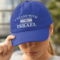 Person wearing a blue cap with 'I Stand With Israel' text and flag design.
