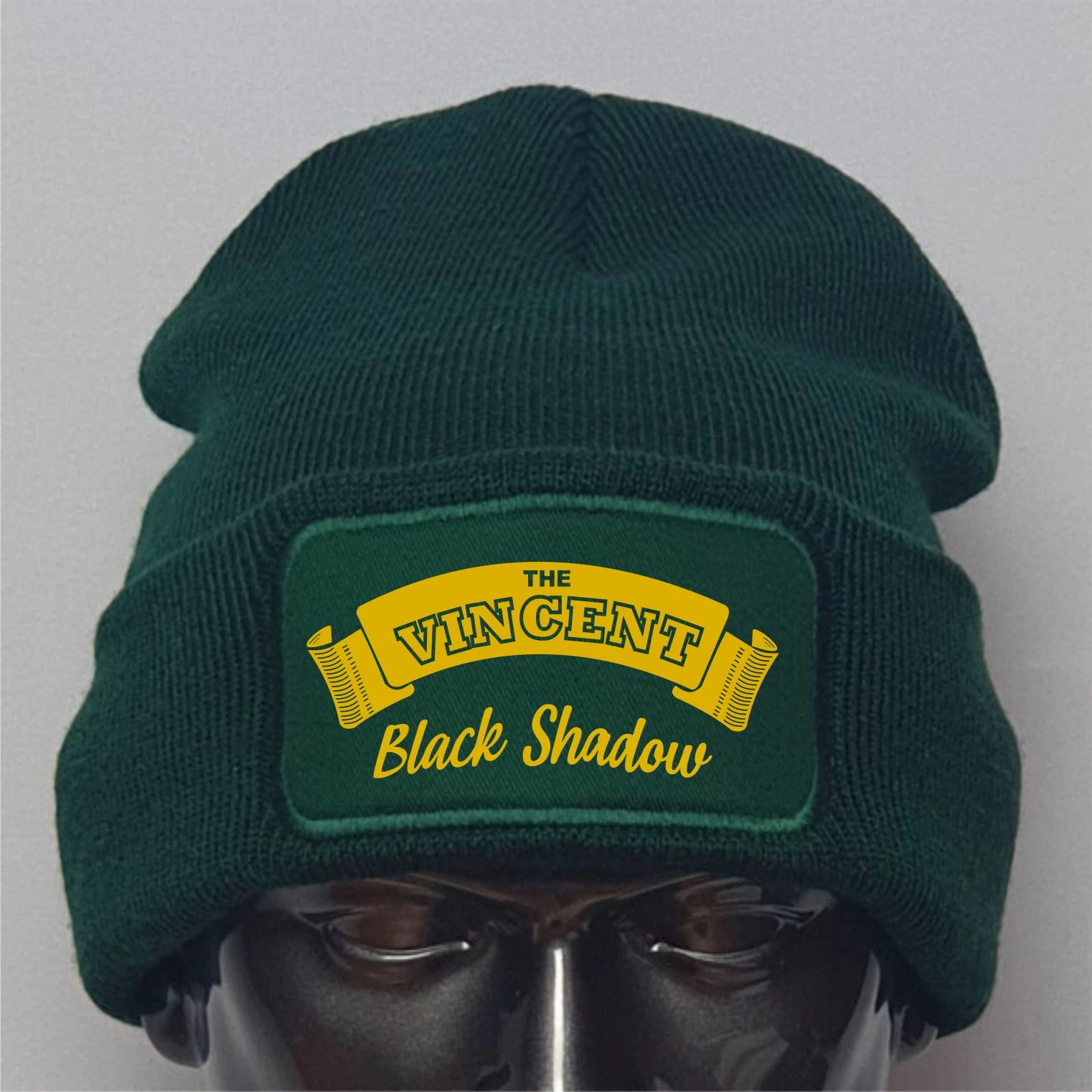 Green beanie with 'The Vincent Black Shadow' logo on a gray background