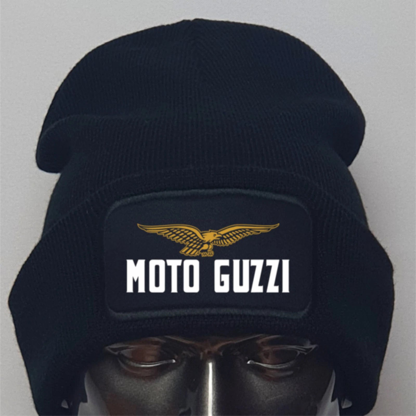 Black beanie with Moto Guzzi logo on a mannequin head against a gray background