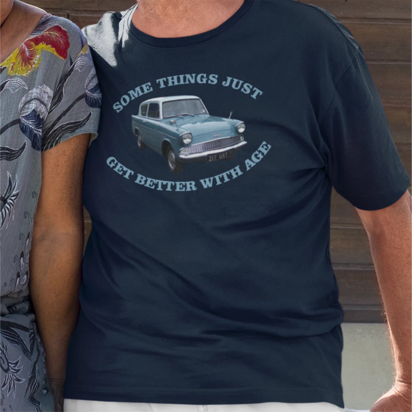 Navy blue t-shirt with vintage car graphic and text worn by a person.