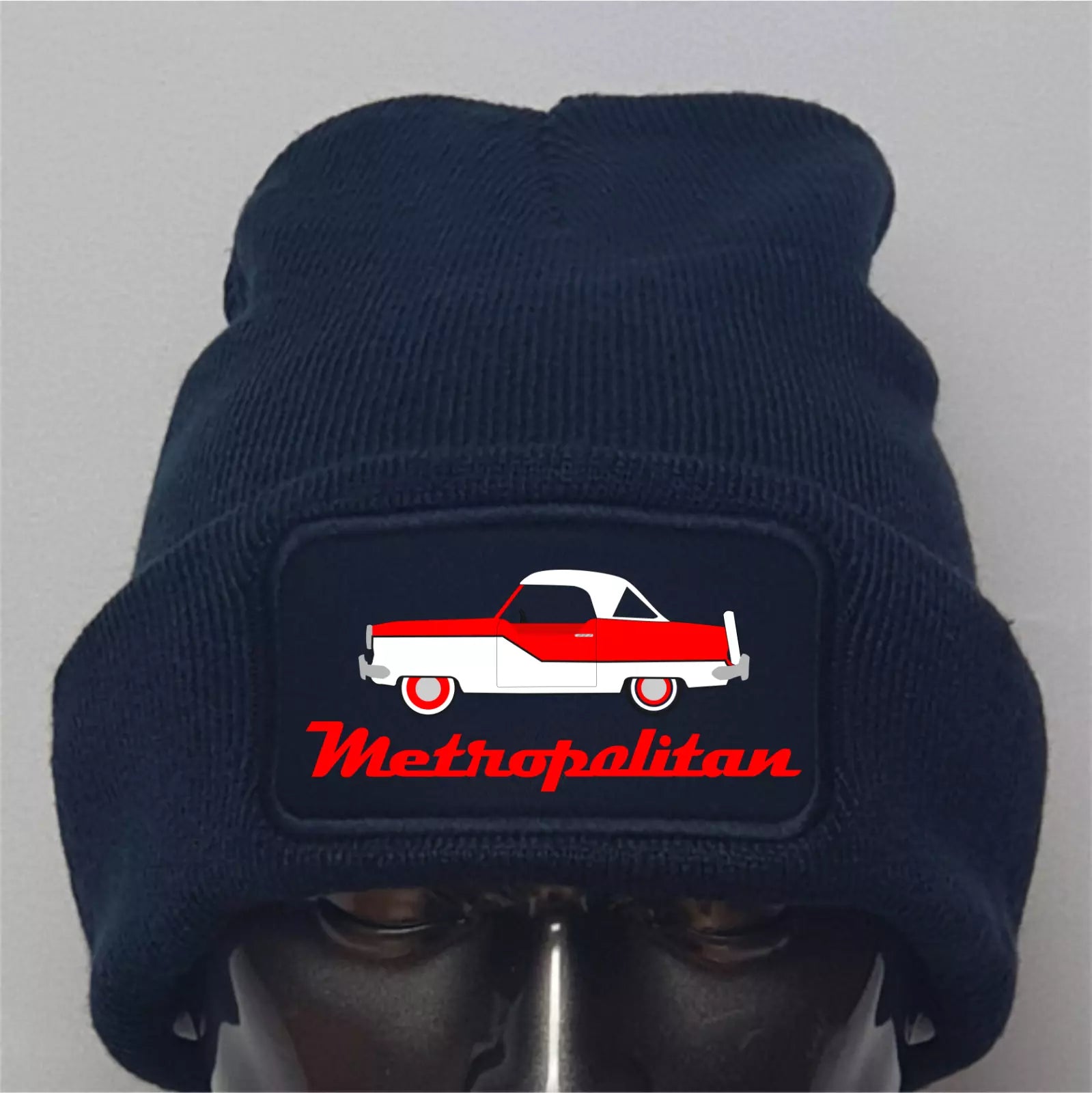 Navy blue beanie with a red and white car design and 'Metropolitan' text on a gray background