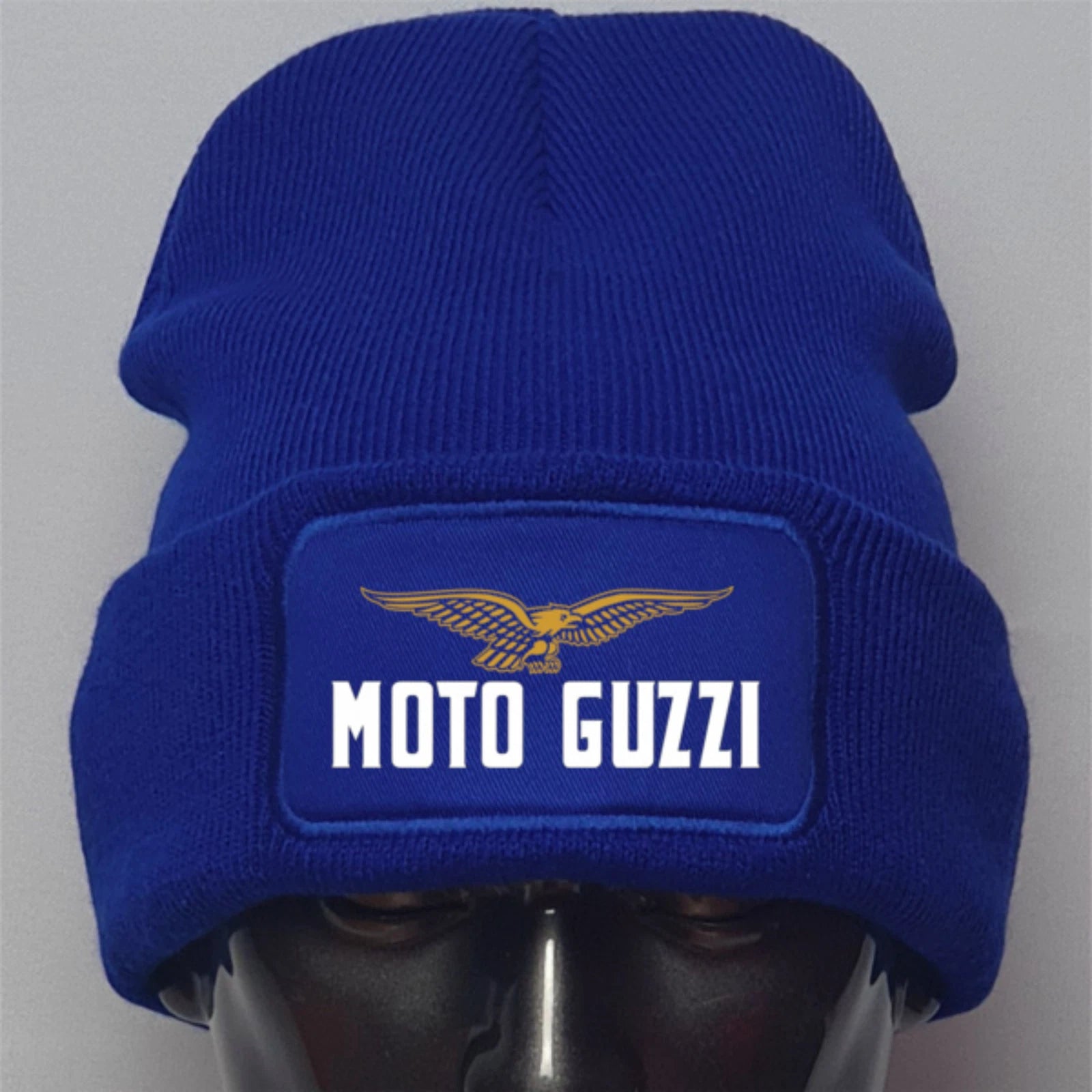 Blue beanie with Moto Guzzi logo on a gray background
