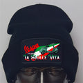 Black beanie with Vespa logo and Italian flag design on a gray background