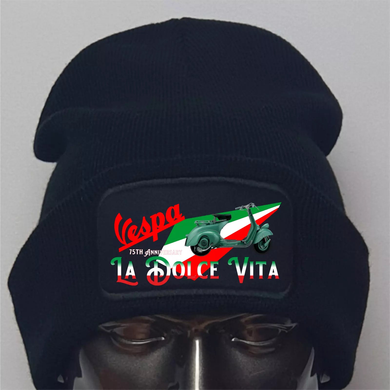 Black beanie with Vespa logo and Italian flag design on a gray background