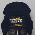 Black beanie with Ariel Arrow motorcycle design on a gray background