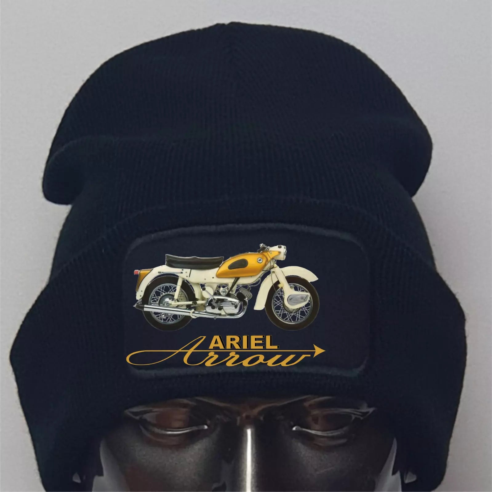 Black beanie with Ariel Arrow motorcycle design on a gray background