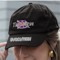 Black cap with Triumph logo and 'Evolution' text worn by a person.