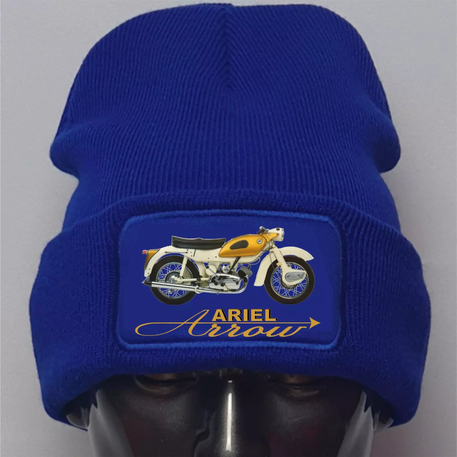 Blue beanie with a motorcycle patch and 'Ariel Arrow' text on a gray background