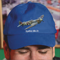 Blue cap with Spitfire Mk.IX design worn by a person, blurred background