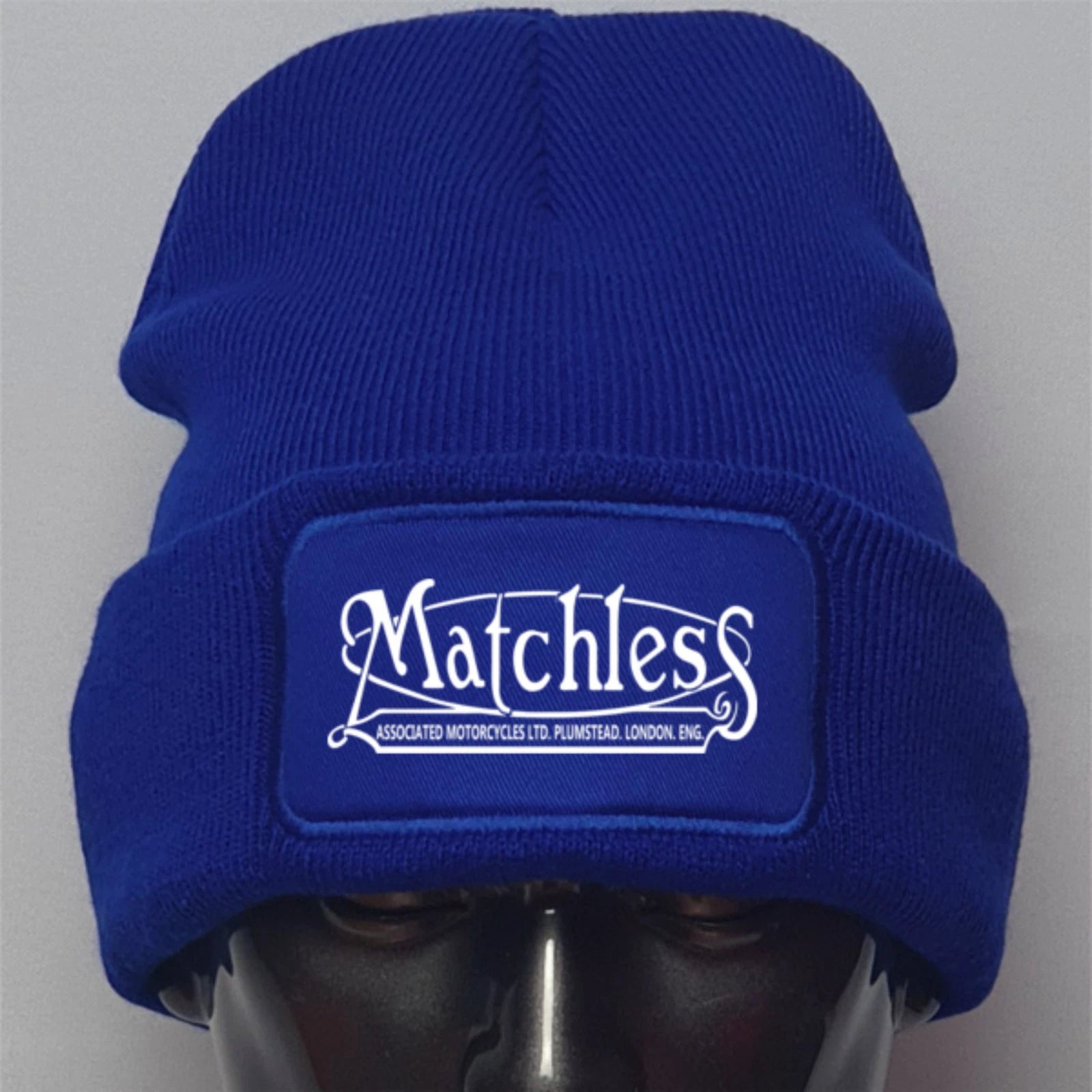 Blue beanie with 'Matchless' logo on a gray background