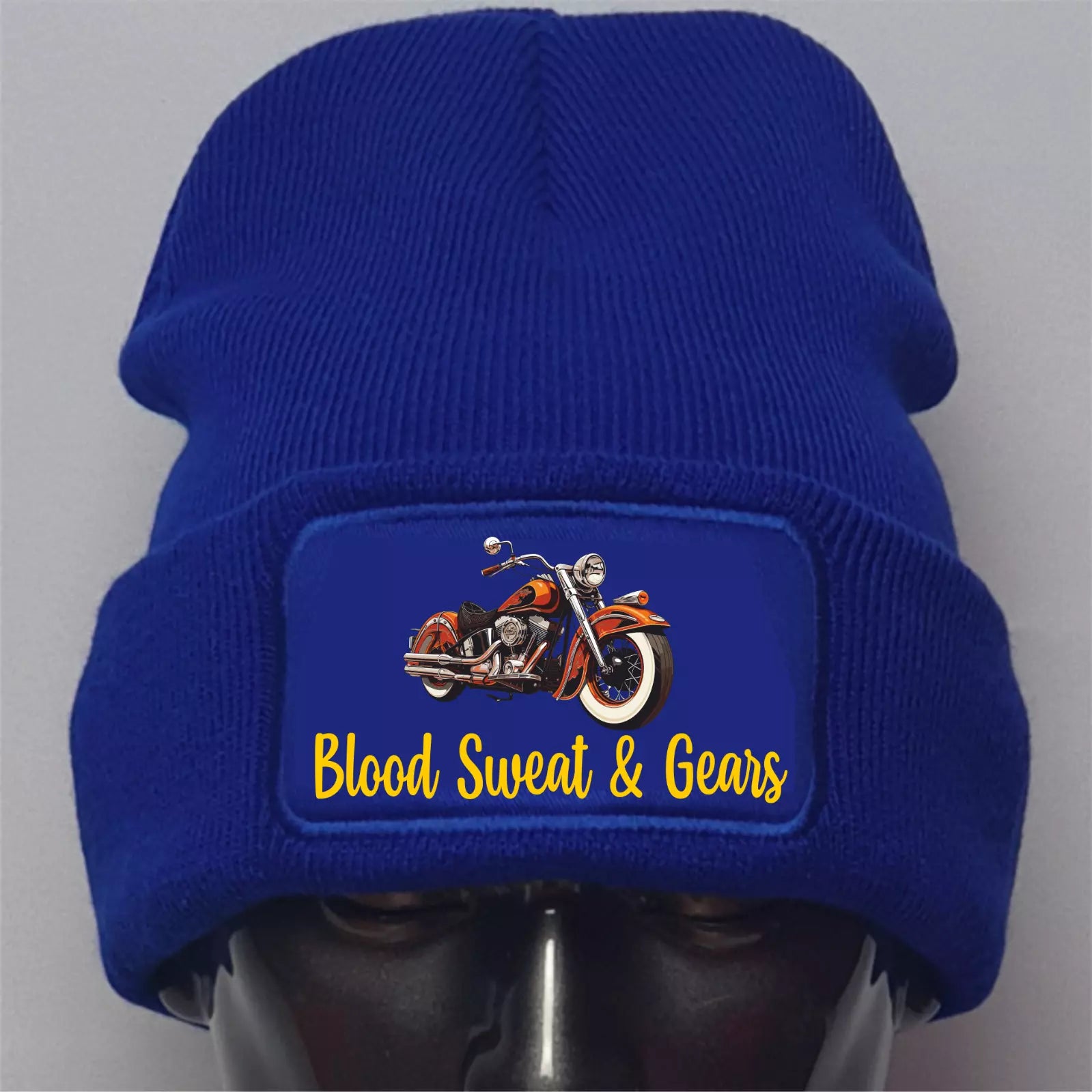 Blue beanie with a motorcycle graphic and 'Blood Sweat & Gears' text on a gray background