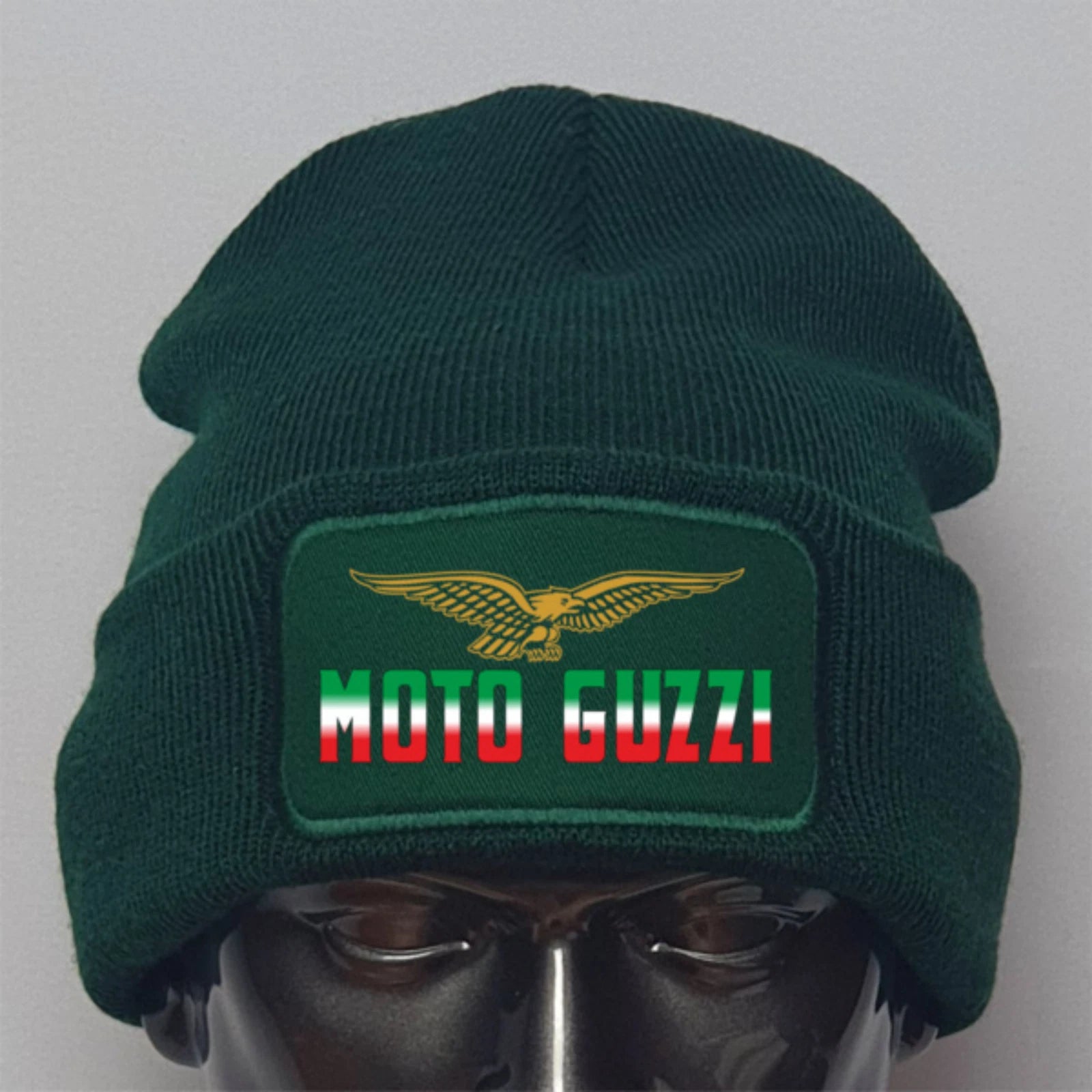 Green beanie with Moto Guzzi logo on a mannequin head against a gray background