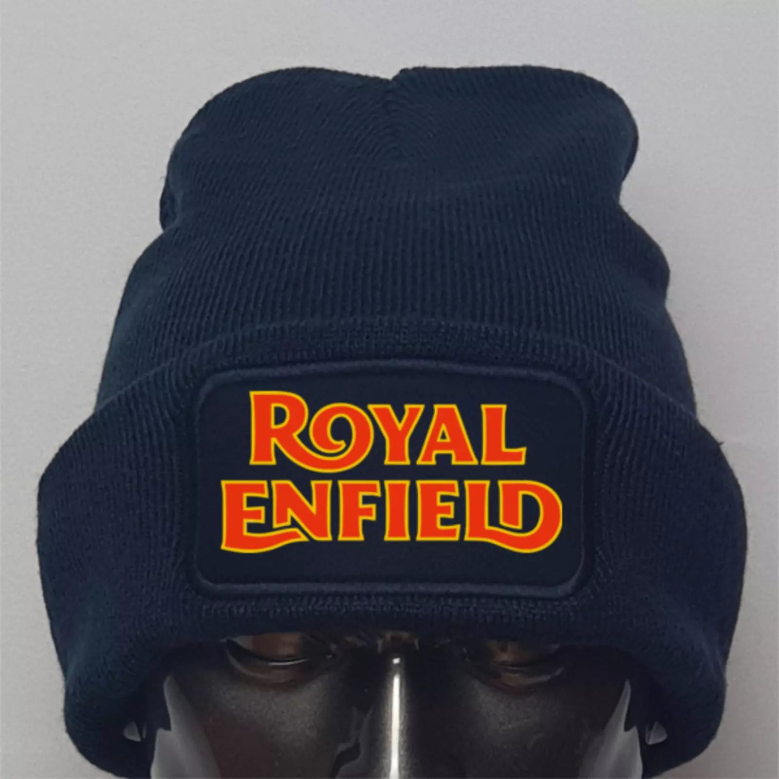 Navy blue beanie with Royal Enfield logo on a gray background