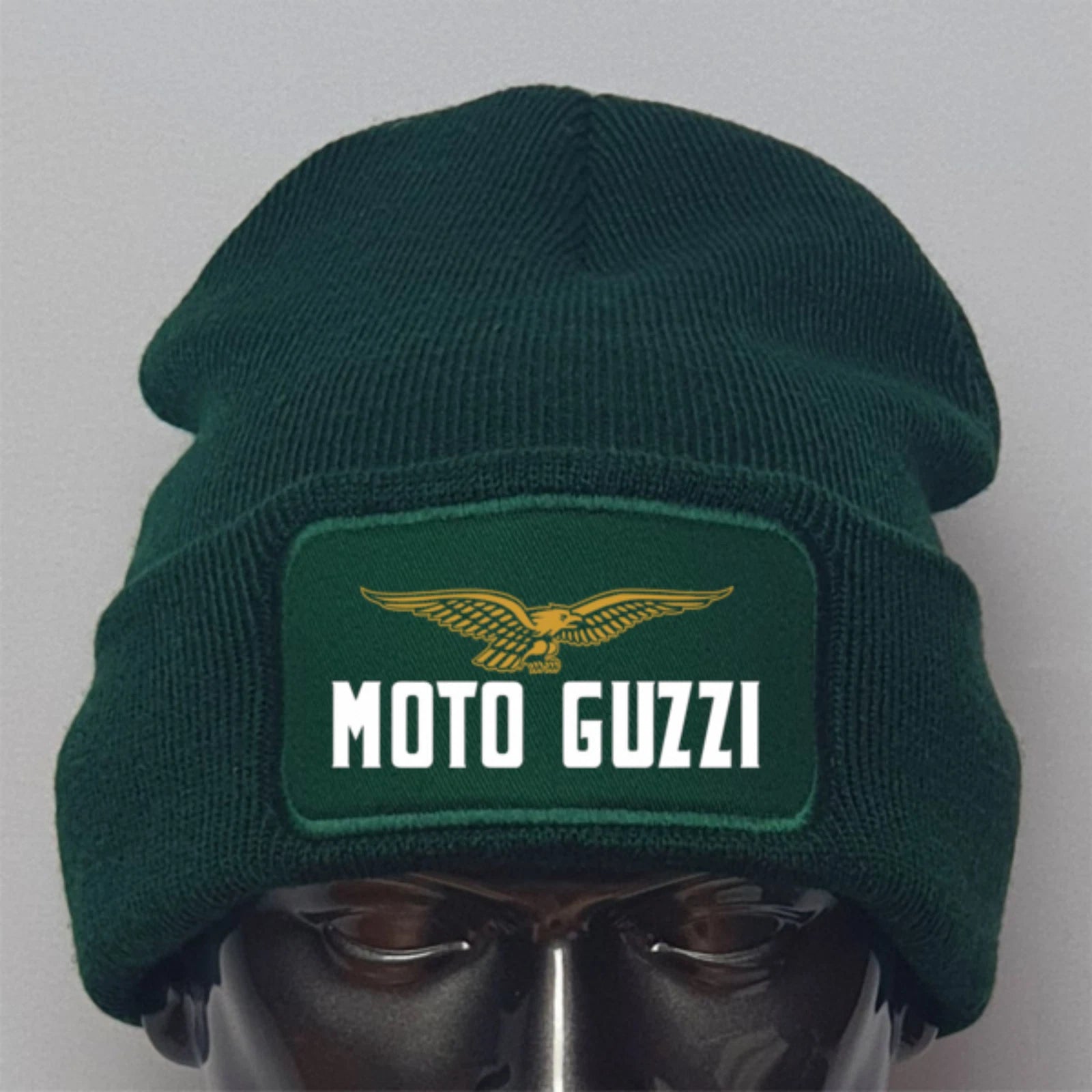 Green beanie with Moto Guzzi logo on a mannequin head against a gray background