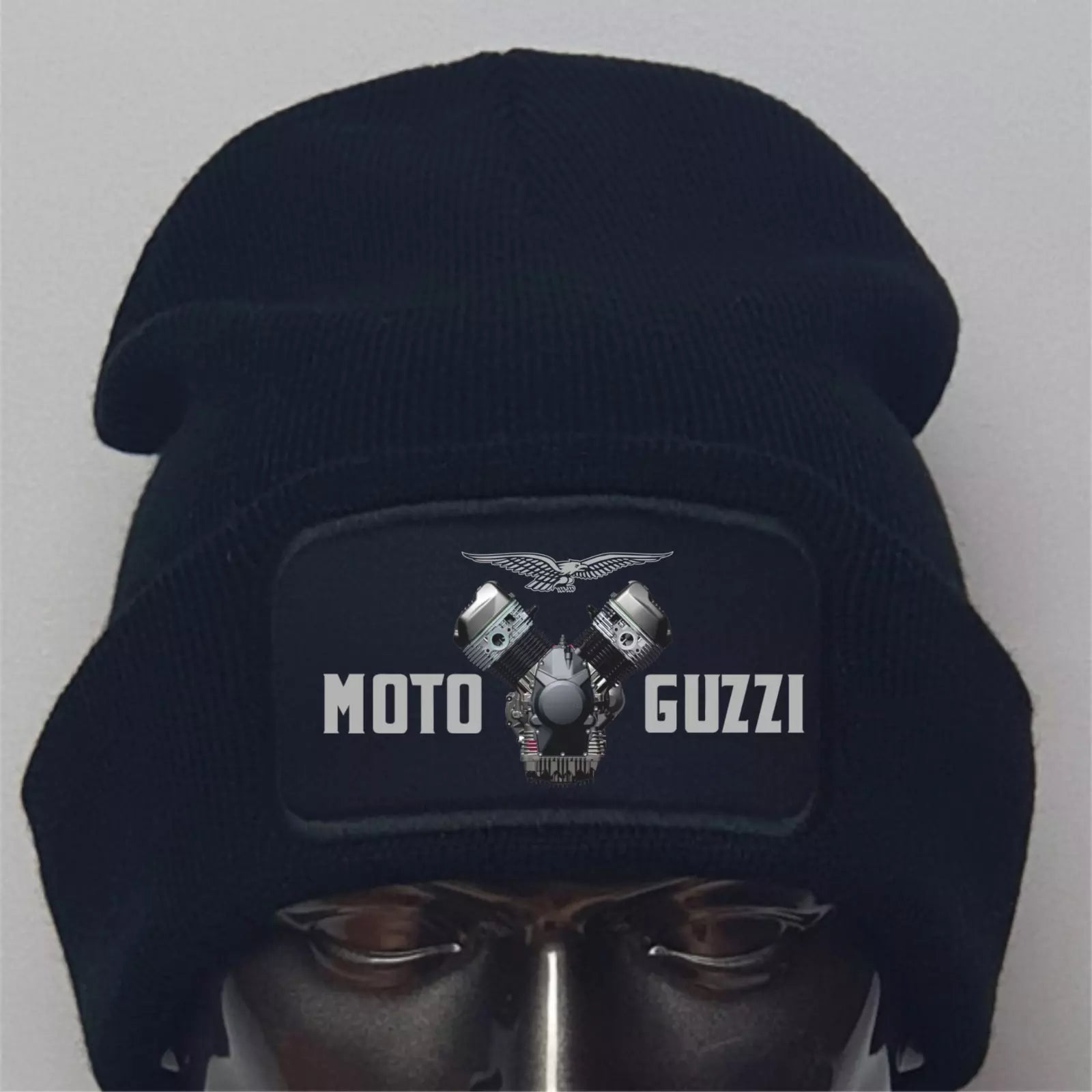 Black beanie with Moto Guzzi logo on a mannequin head against a gray background