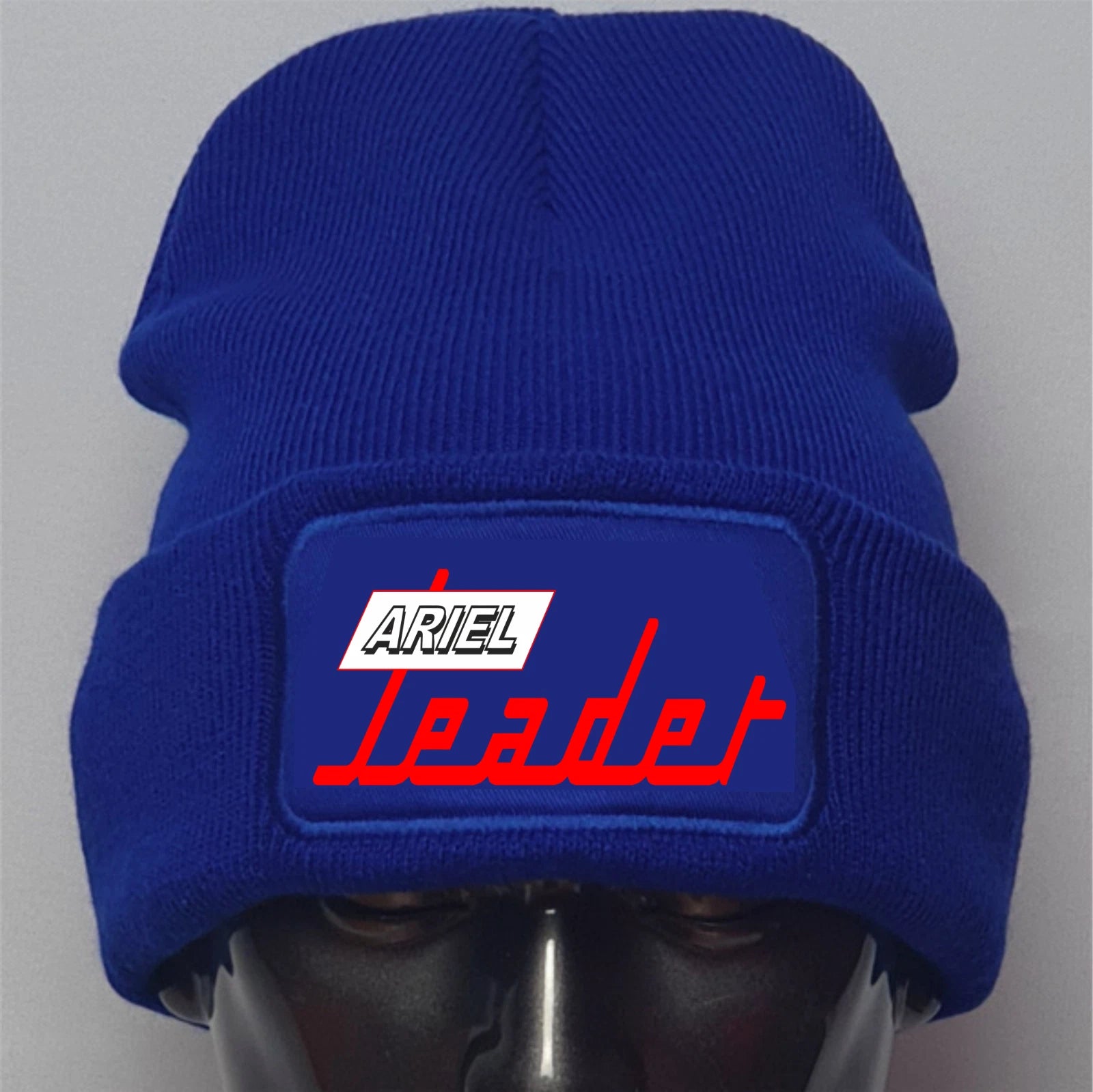 Blue beanie with 'Ariel Leader' logo on a gray background