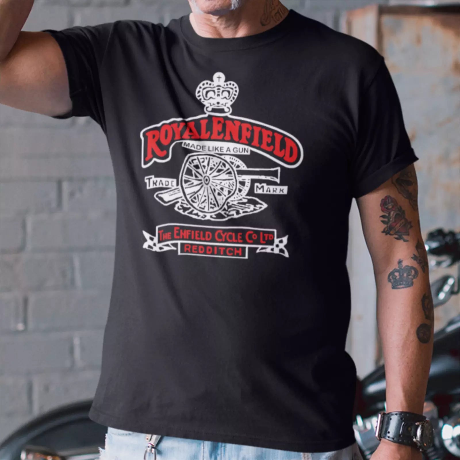 Person wearing a black t-shirt with 'Royalenfield' branding and design.