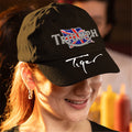 Person wearing a black cap with Triumph logo and 'Tiger' text, blurred background